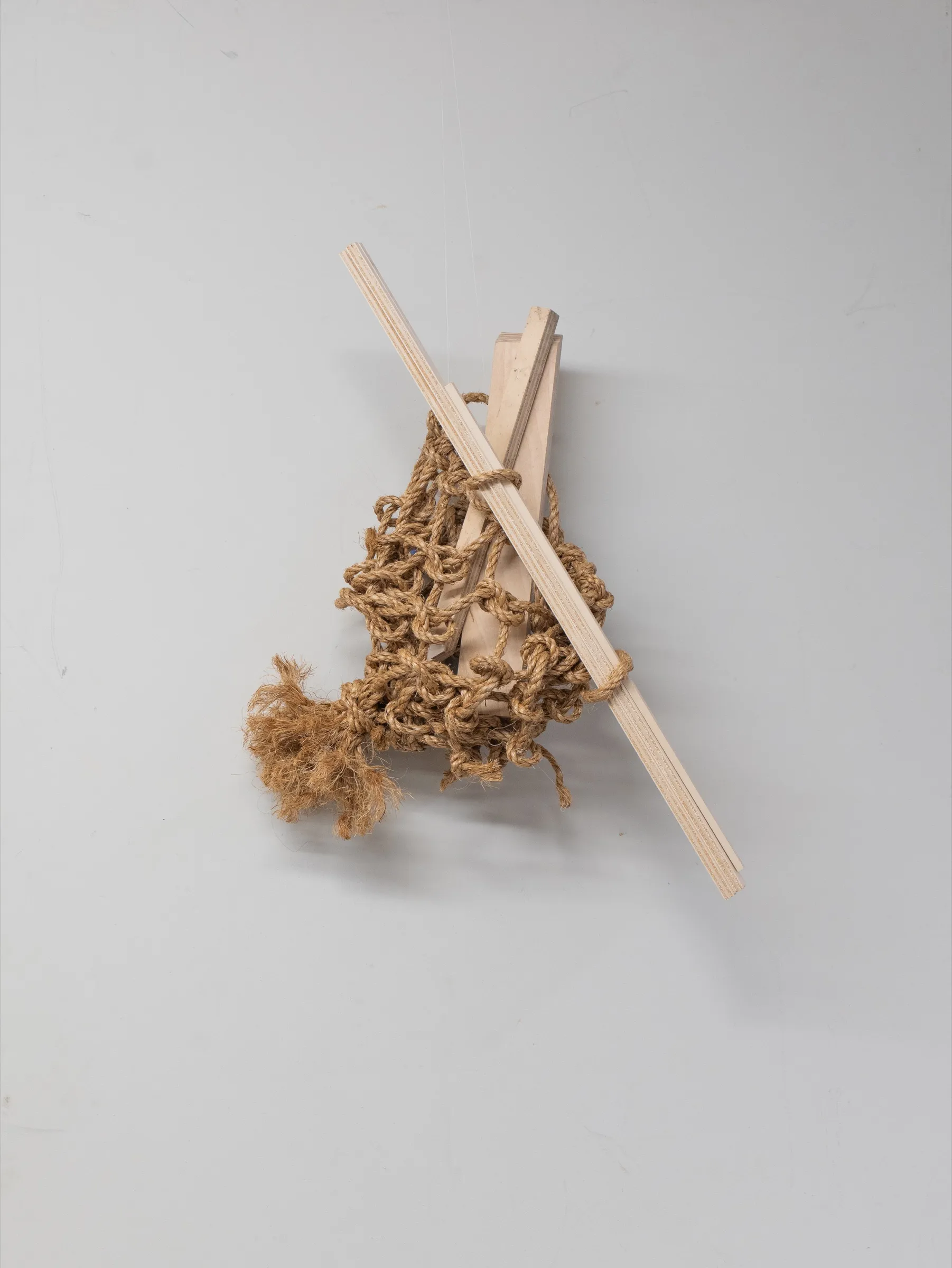 The rope cradle adjusted around several narrow pieces of timber.